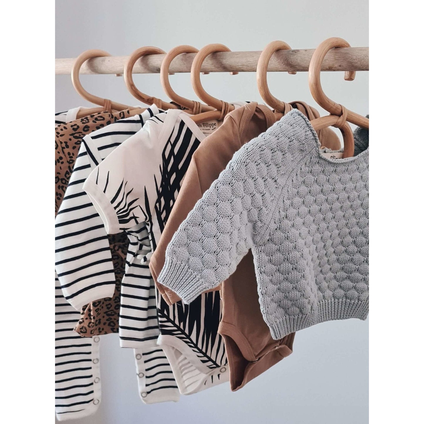 https://www.petitfilippe.com/cdn/shop/products/rattan-baby-clothes-hangers-set-of-3-401221.jpg?v=1666705934&width=1445
